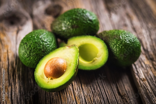 Avocados on wooden background