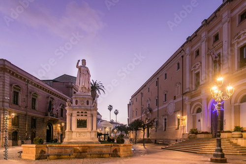 Olbia by Night, statue, lamp post and buldings