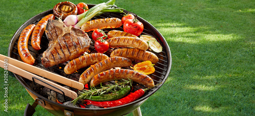 Meat and vegetables grilling on an outdoor BBQ