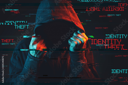 Online identity theft concept with faceless hooded male person