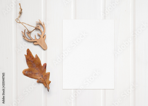 Top view composition made of autumn leaf and wooden reindeer decoration top view, copy space.