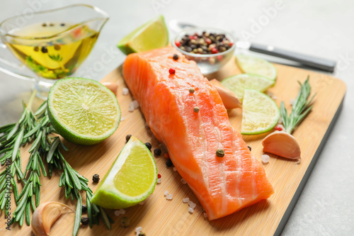 Fresh salmon and ingredients for marinade on wooden board