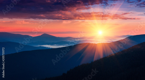 Panoramic view of colorful sunrise in mountains. Concept of the awakening wildlife, romance,emotional experience in your soul, joy in mundane life.