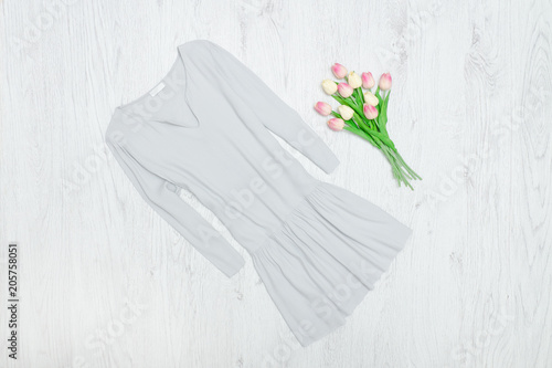 Gray dress and bouquet of tulips. Fashionable concept