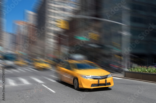 New York City yellow taxi cab speeding through the streets of Manhattan with motion blur effect