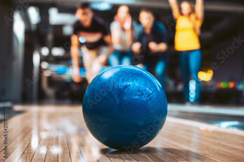 Friends having fun while bowling, selective focus