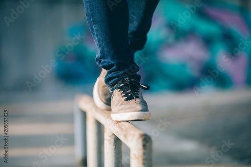 Legs walking on steel pipe with balance