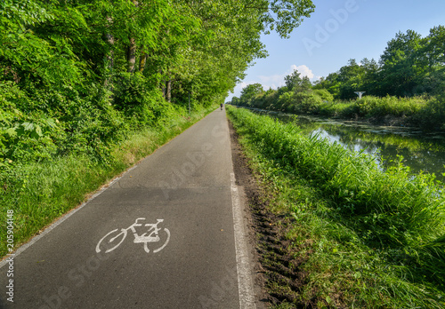 Empty cycling path along the Naviglio Pavese, canal which stretches for 30km from Pavia to Milan, Italy.