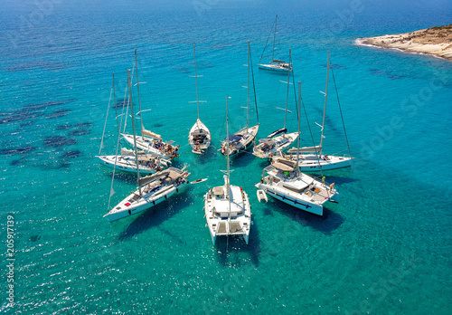 Stunning Aerial View of Sailing Boats in Turquoise Tropical Bay Arranged in a Star Formation