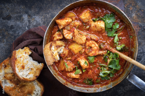 Traditional Creole cajun court bouillon with fish and seafood gumbo chowder stew as top view in a pot