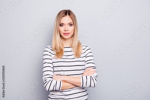 Portrait with copy space, empty place for advertisement of stylish, attractive, charming, nice woman having her arms crossed looking at camera isolated on grey background
