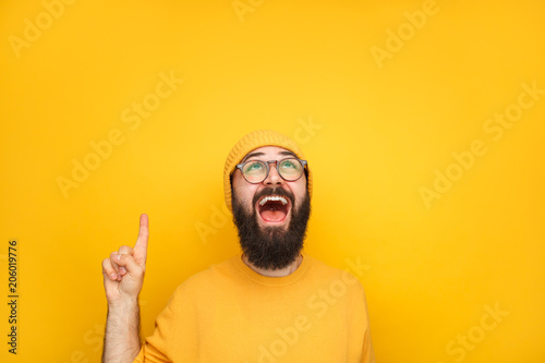 Excited guy in yellow pointing up