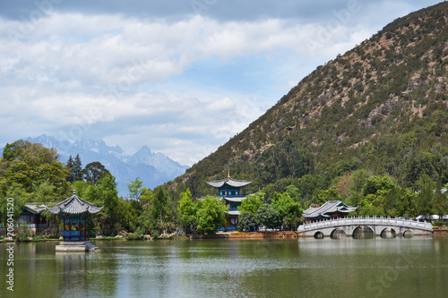 Landscape of Black Dragon Pool and snow mountain in background at Lijiang, Yunnan, China.