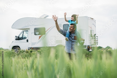 Father and son with the holiday caravan