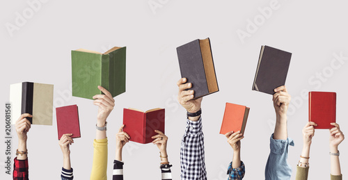 The hands of people hold books