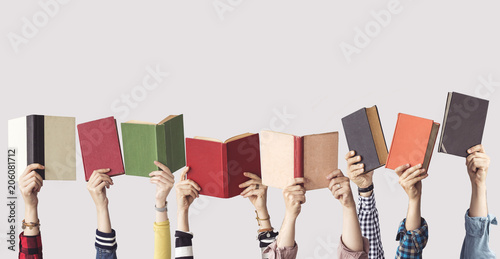 The hands of people hold books