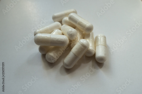 Closeup of heap of white capsules of magnesium citrate