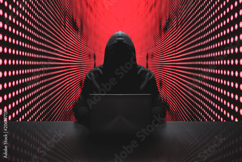 Anonymous hacker in front of his computer