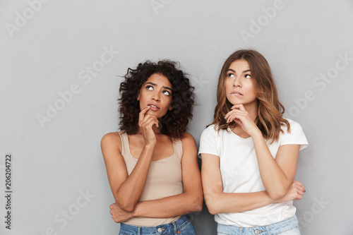Portrait of two pensive young women looking away