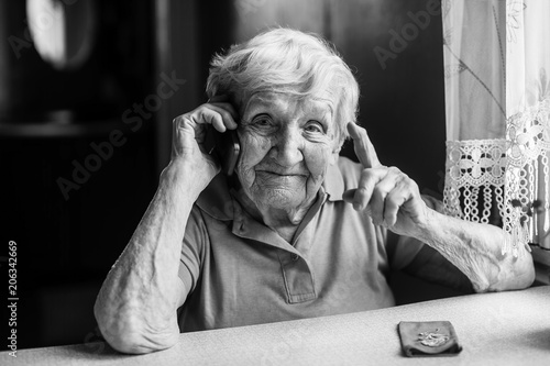 Elderly woman talks on a mobile phone.