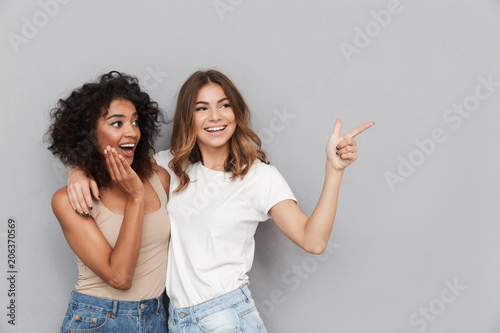 Portrait of two cheerful young women standing together