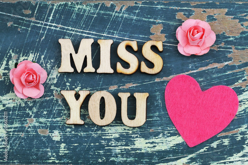 Miss you written with wooden letters on rustic surface 
