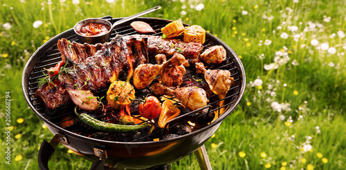 Spicy spare ribs and chicken grilling on a BBQ