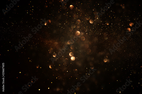 glitter vintage lights background. dark gold and black. de focused.