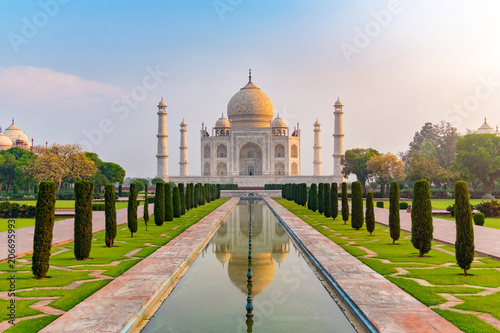 Taj Mahal front view reflected on the reflection pool, an ivory-white marble mausoleum on the south bank of the Yamuna river in Agra, Uttar Pradesh, India. One of the seven wonders of the world.