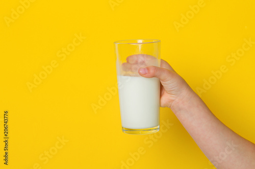 hand with glass of milk