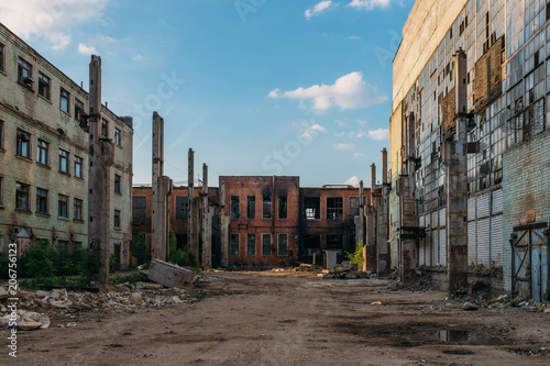 Territory of abandoned industrial area waiting for demolition. Broken and burnt buildings. Former Voronezh excavator factory