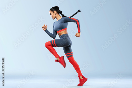 A strong athletic, women sprinter, running wearing in the sportswear, fitness and sport motivation. Runner concept with copy space. Dynamic movement