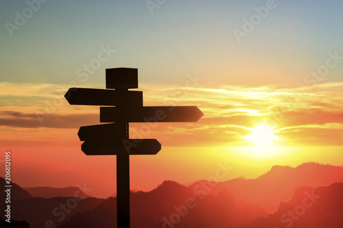 Silhouette of a signpost in a colorful sunset