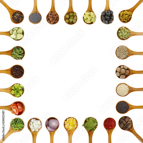 spices in wooden spoons isolated