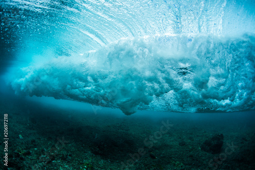 Underwater view of the ocean wave breaking over coral reef