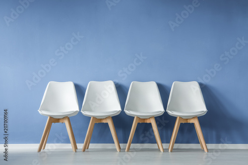 Row of chairs against wall