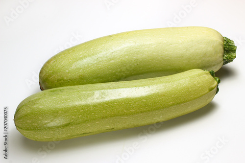 Green courgettes on a white background