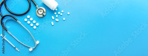 Pills and medical equiupments on light blue banner background