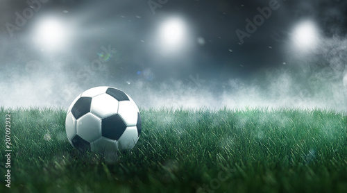 Soccer ball or football in a misty sports stadium