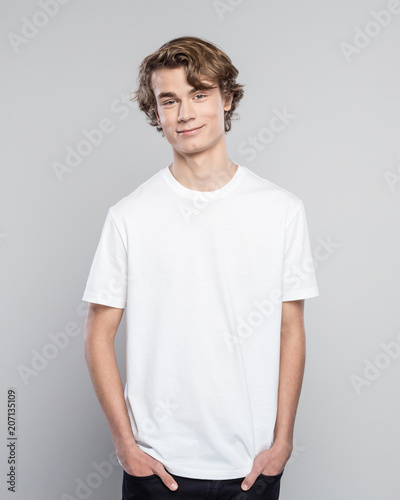 Portrait of friendly teenager in white t-shirt