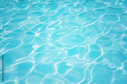 Blue and bright ripple water and surface in swimming pool, Beautiful motion gentle wave in pool