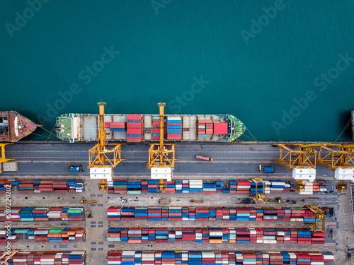 Top view of international port with Crane loading containers in import export business logistics.