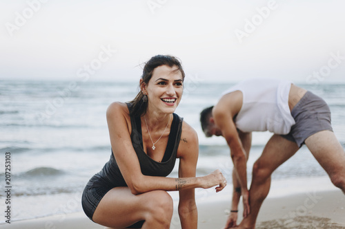 Couple stretching at the beach