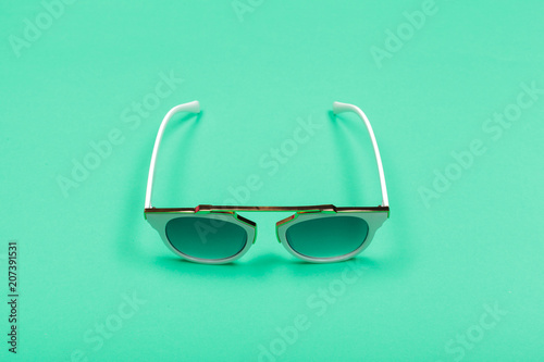 Top view. Fashion sunglasses on pastel background