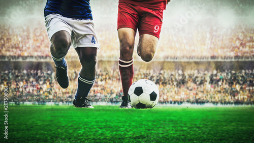 Two soccer football player dribbling a ball during match in the stadium