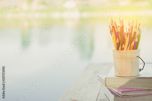 School supplies on wooden table desk nature green background empty space. Natural classroom concept.