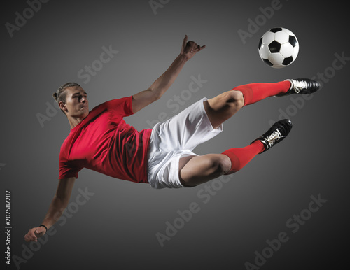 Soccer player in action on black background.