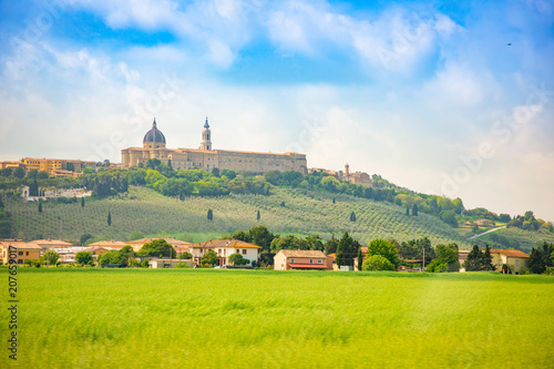 Loreto, Basilica over summer fields in Italian province of Ancona, Italy