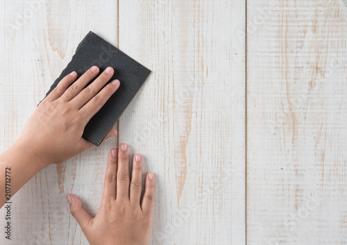 Sanding and smoothing wood with black sandpaper