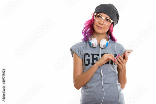 Studio shot of geek girl holding mobile phone while thinking wit